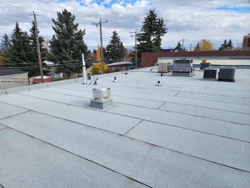 Completed flat roof system around rooftop units