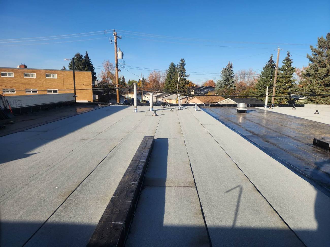 Clean membrane field on a low-slope commercial roof