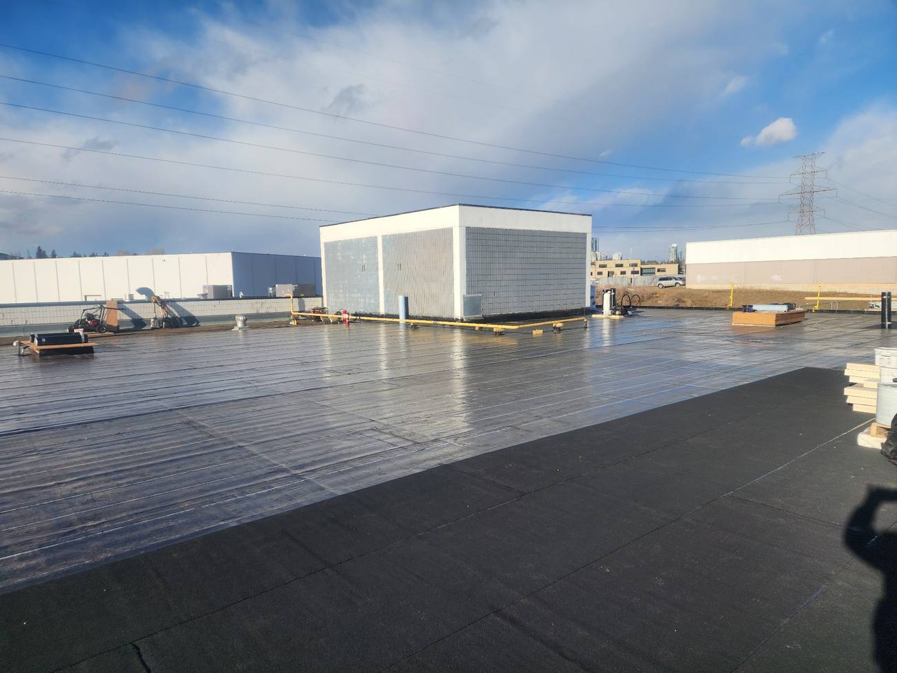 Two-ply SBS torch-on membrane going down on a Calgary commercial flat roof