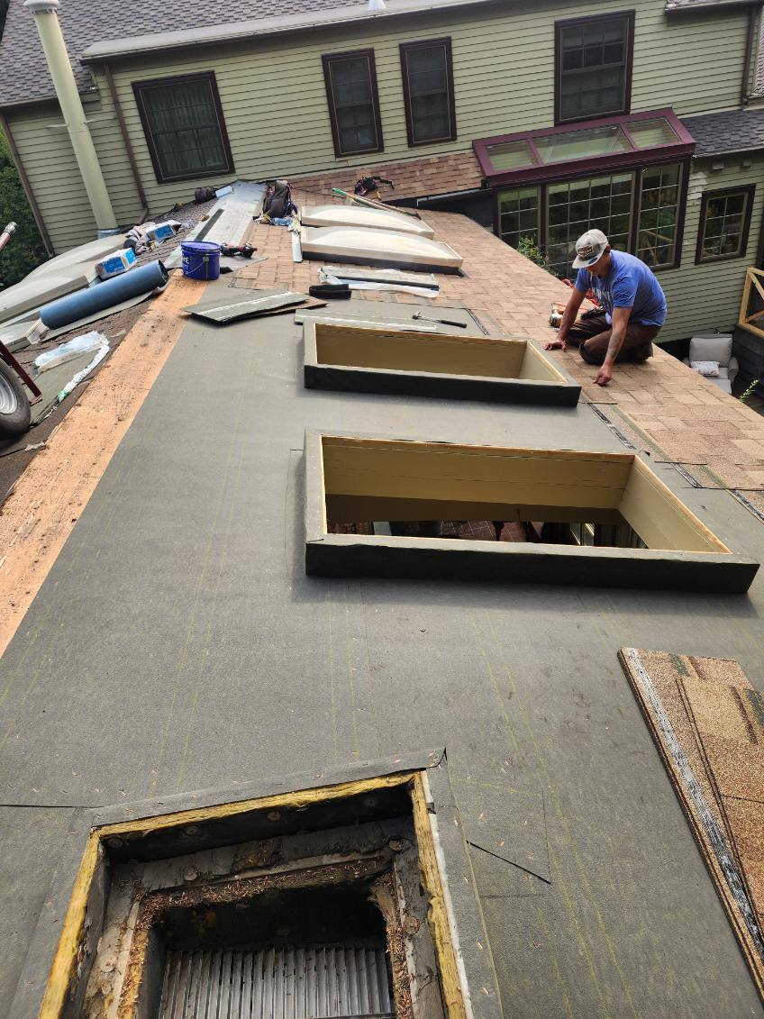Rebuilding skylight curbs during a roof repair