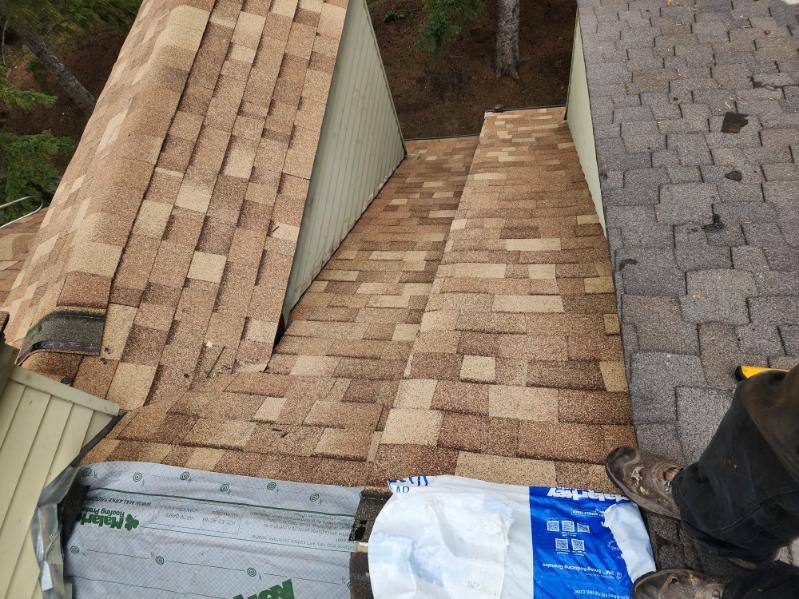 Valley work in progress on a shingle roof