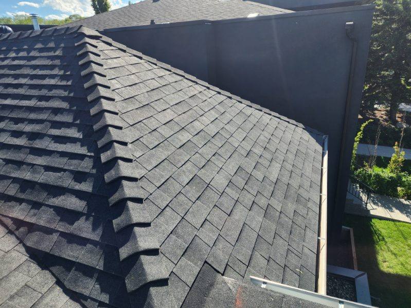 Crisp ridge cap detail on a completed shingle roof